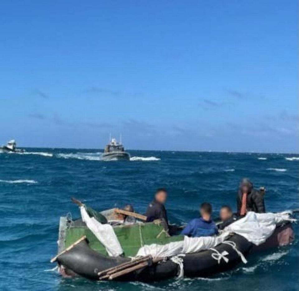 The makeshift raft and the five Cubans who said they had been on the raft for 16 days.