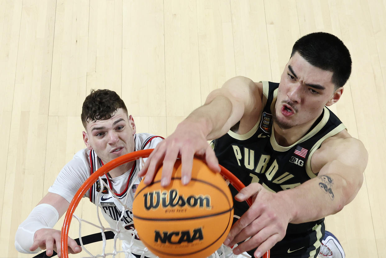 GLENDALE, ARIZONA - APRIL 08: (EDITORS NOTE: Image taken using a remote camera.) Zach Edey #15 of the Purdue Boilermakers dunks over Donovan Clingan #32 of the Connecticut Huskies during the first half in the NCAA Men's Basketball Tournament National Championship game at State Farm Stadium on April 08, 2024 in Glendale, Arizona. (Photo by Jamie Schwaberow/NCAA Photos via Getty Images)
