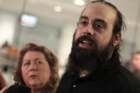 Canadian Greenpeace activist Alexandre Paul (R) speaks to the media as his mother Nicole Paul looks on following his arrival at the airport in Montreal, December 27, 2013. Paul was detained by Russia for more than three months following a protest against Arctic oil drilling in international waters. REUTERS/Christinne Muschi (CANADA - Tags: ENVIRONMENT CIVIL UNREST CRIME LAW)