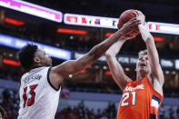 Syracuse forward Marek Dolezaj (21) is fouled by Louisville guard David Johnson (13) during the first half of an NCAA college basketball game Wednesday, Feb. 19, 2020, in Louisville, Ky. (AP Photo/Wade Payne)
