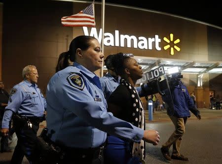 A protestor is taken into custody during a demonstration at a Walmart store in St. Louis, Missouri, October 13, 2014. REUTERS/Jim Young