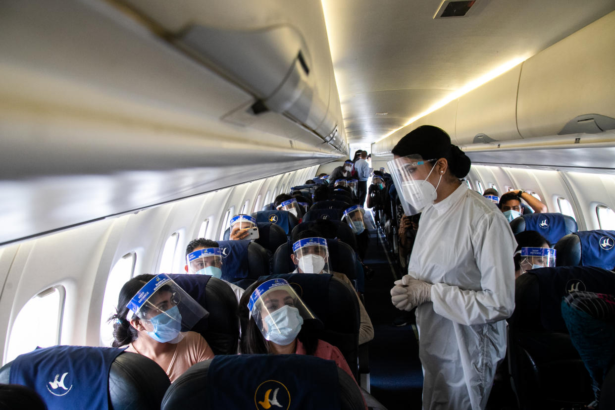 2020/06/25: An air hostess of Buddha Air wearing a protective suit attends to passengers inside the aircraft during a mock safety drill. (Photo by Prabin Ranabhat/SOPA Images/LightRocket via Getty Images)