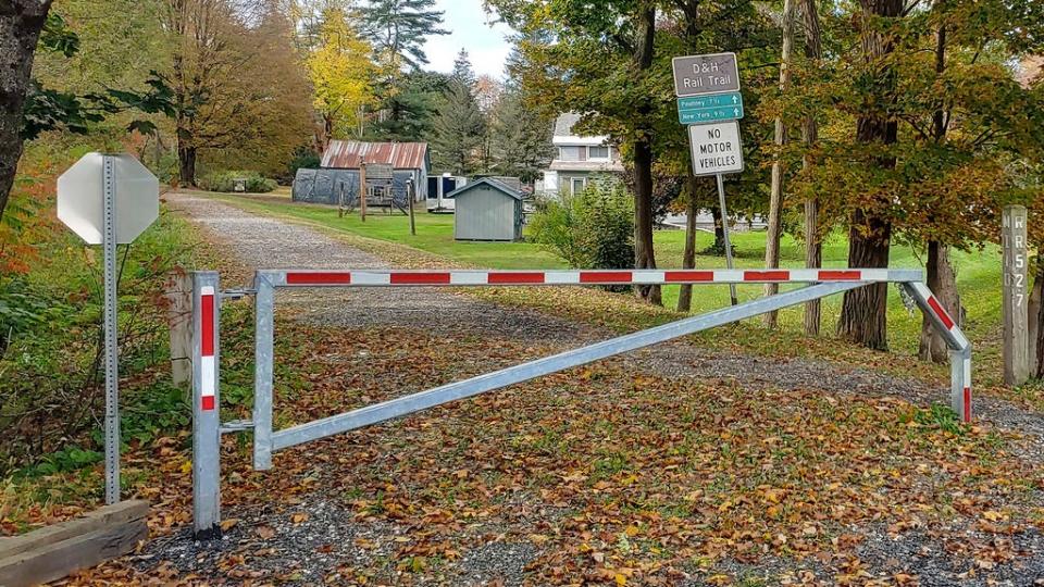 Signs and a closed gate stand at an entrance to the Delaware & Hudson Rail Trail, Monday, Oct. 9, 2023, in Castleton, Vt. Police said an autopsy showed that retired dean and professor Honoree Fleming, of Castleton, Vt., died from a gunshot wound to the head on Thursday, Oct. 5. She was found on the trail about a mile south of the Castleton campus of Vermont State University.