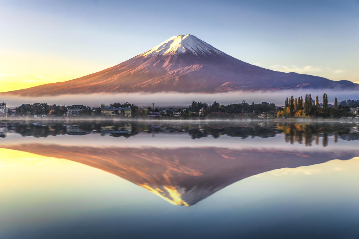 Fuji Mountain Reflection with Morning Mist in Autumn, Kawaguchiko Lake, Japan. Photo: Getty