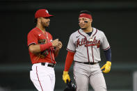 Atlanta Braves' William Contreras, right, talks with Washington Nationals shortstop Luis Garcia, left, during the fourth inning of a baseball game, Wednesday, June 15, 2022, in Washington. (AP Photo/Nick Wass)
