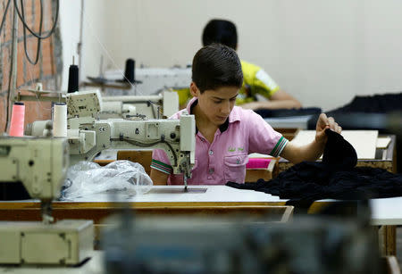 Muhamed, a Syrian refugee boy, works at a small textile factory in Istanbul, Turkey, June 24, 2016. REUTERS/Murad Sezer