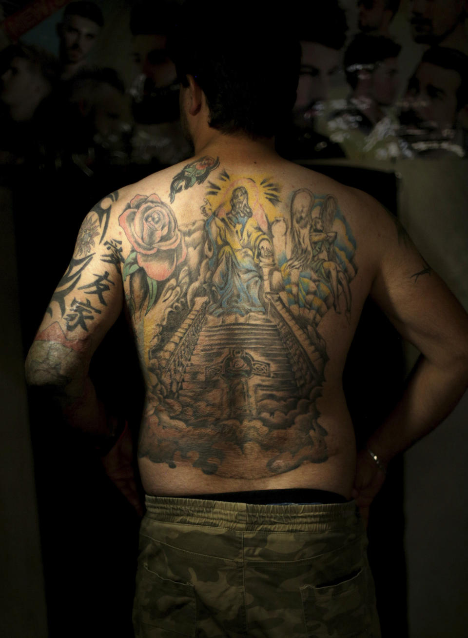 In this Wednesday. Oct. 24, 2018, Iraqi soldier Saad Khudeir displays tattoos on his body to cover scars of the burns he was injured in a car bomb, in Baghdad, Iraq. In 2008, Khudeir lost his fiancee and suffered burns on his body when a car bomb went off near his home in Sadr City, a district on the eastern side of the capital. Four years later, he endured burns in nearly 70 percent of his body when a suicide bomber rammed his explosives-laden car into his convoy in the then restive city of Fallujah.(AP Photo/Hadi Mizban)