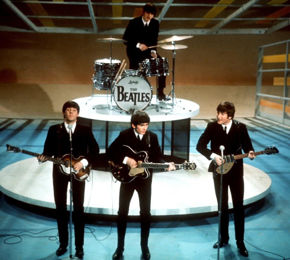 Paul McCartney, left, George Harrison, John Lennon and Ringo Starr on drums perform on the CBS "Ed Sullivan Show" in New York on Feb. 9, 1964. The appearance was a landmark television event that led to a still-going love affair between American music lovers and the British band.