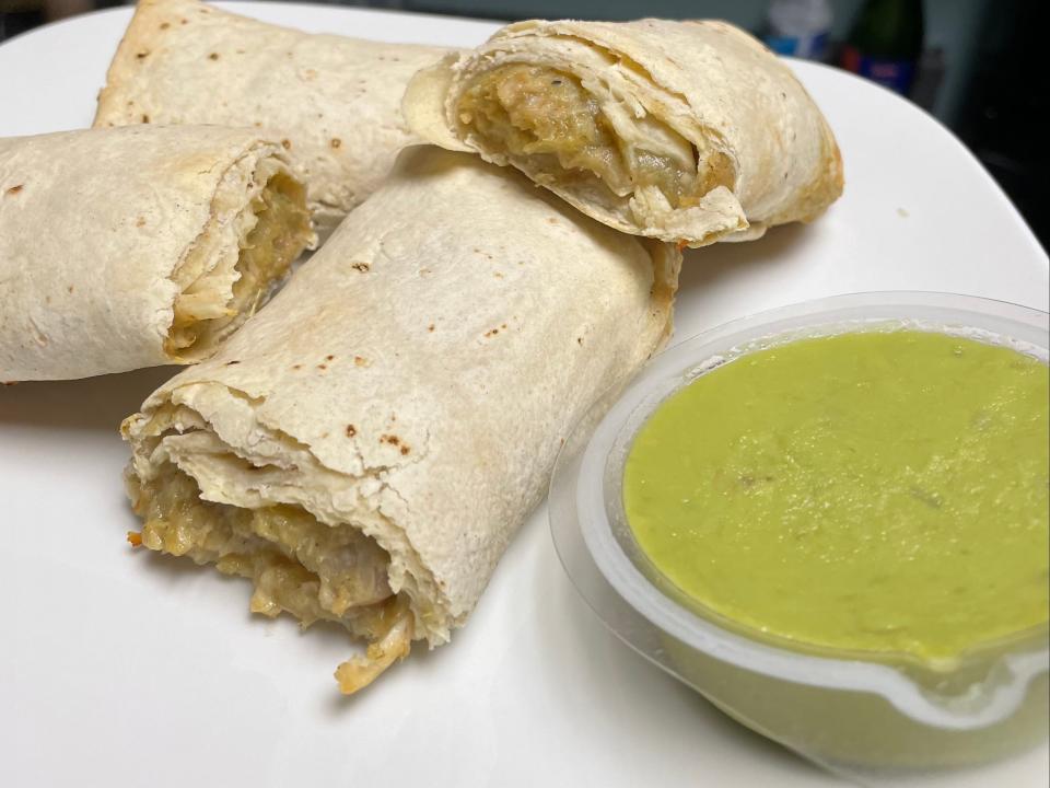 cooked chicken verde burrito with guacamole