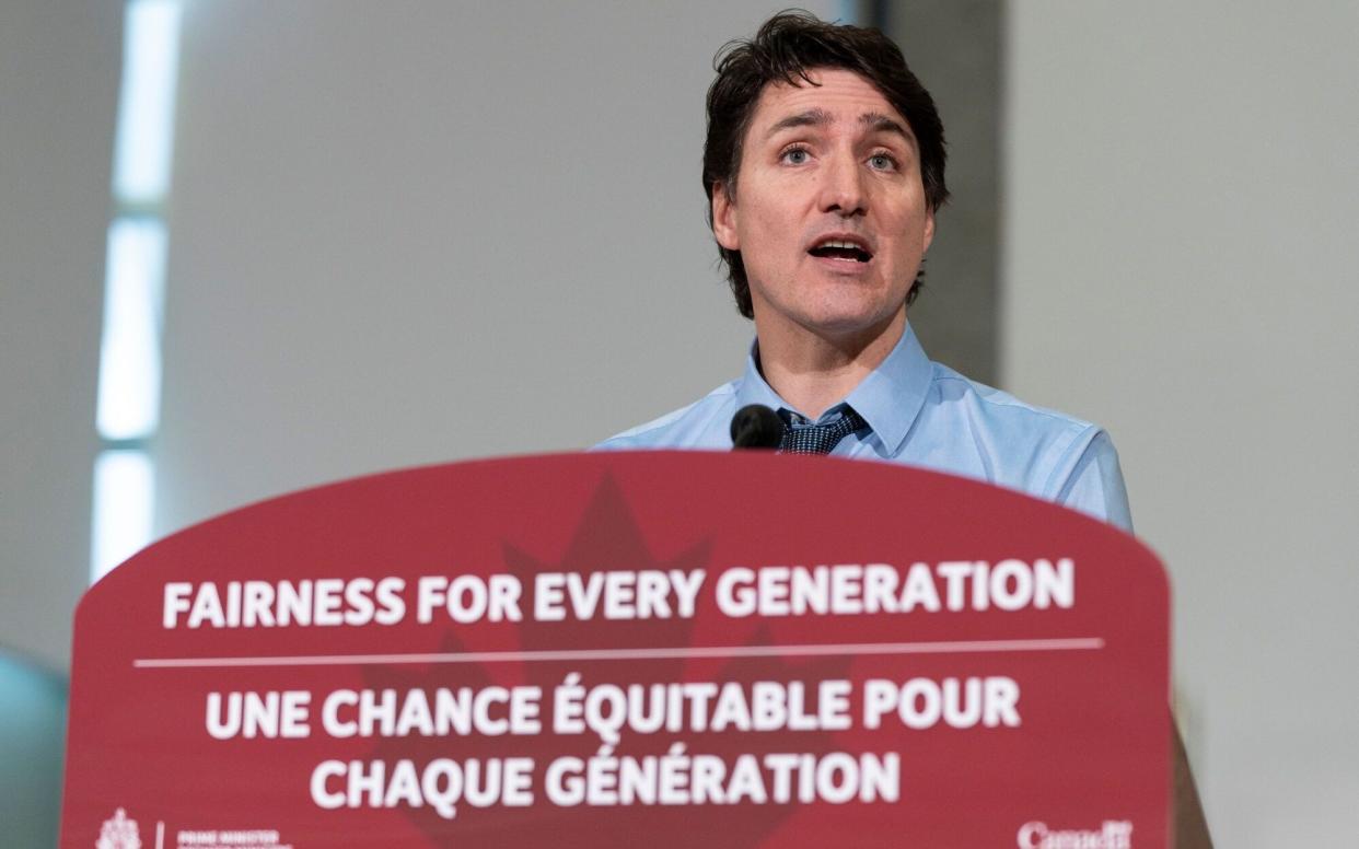Justin Trudeau speaking at a news conference in March 2024, with no jacket on