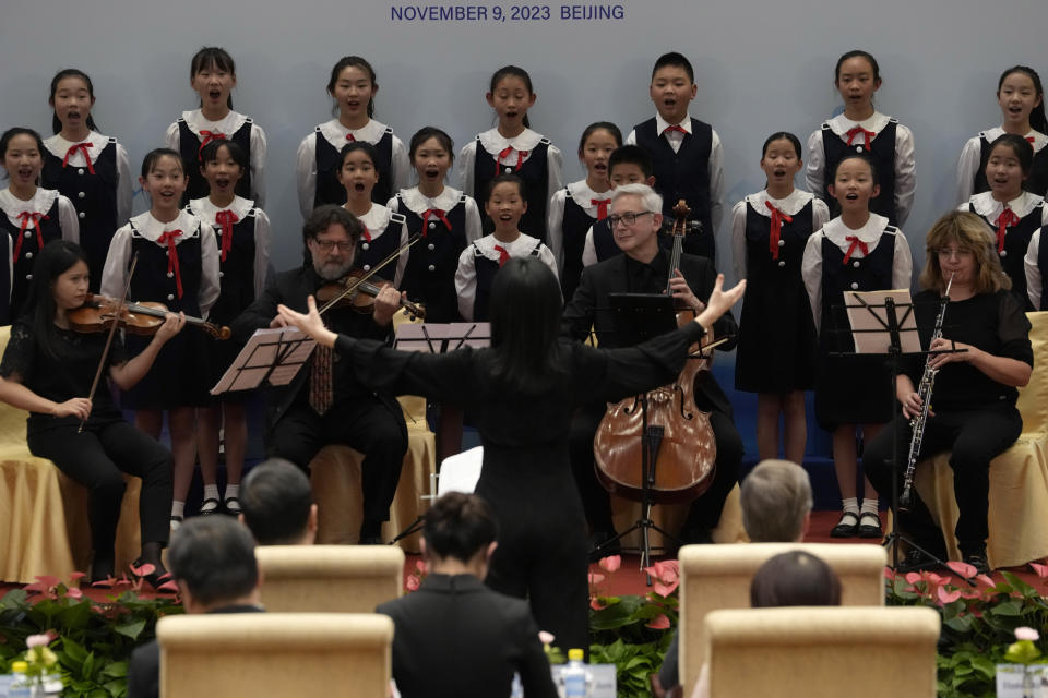 FILE - Musicians from the Philadelphia Orchestra perform onstage with children from the Beijing Philharmonic Choir before a reception to commemorate the 50th anniversary of the Philadelphia Orchestra's first concert in China at the Diaoyutai state guesthouse in Beijing on Nov. 9, 2023. (AP Photo/Ng Han Guan, File)