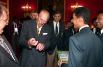 <p>The Duke of Edinburgh pulls a face while talking with Pakistan’s captain and wicket keeper Kashif Mahmood (R) during a reception for the under 15 cricket teams at St James’s Palace, London. The Duke was talking about getting broken fingers while playing cricket. The reception was held for the eight teams playing in the under 15 World Cricket Challenge. (Photo credit: PA/PA Archive/PA Images) </p>