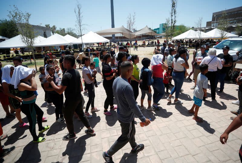 FILE PHOTO: Asylum seekers camp out near the border as they try to cross into the U.S. without an appointment, in Nuevo Laredo