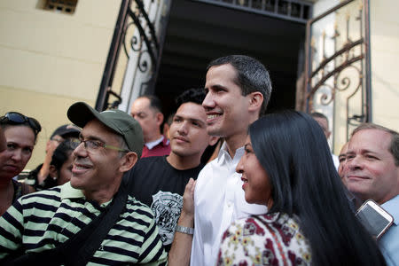 Venezuelan opposition leader Juan Guaido, who many nations have recognised as the country's rightful interim ruler, greets supporters after his visit to La Chiquinquira church in Maracaibo, Venezuela, April 13, 2019. REUTERS/Ueslei Marcelino