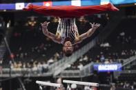 Sam Mikulak of the United States performs on the parallel bars during the American Cup gymnastics competition Saturday, March 7, 2020, in Milwaukee. (AP Photo/Morry Gash)