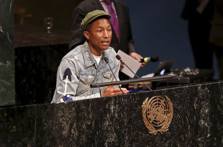 Musician Pharrell Williams addresses youth gathered in the United Nations General Assembly hall on the occasion of the International Day of Happiness on the theme "Young People in Support of Climate Action" at U.N. headquarters in New York, March 20, 2015. REUTERS/Mike Segar