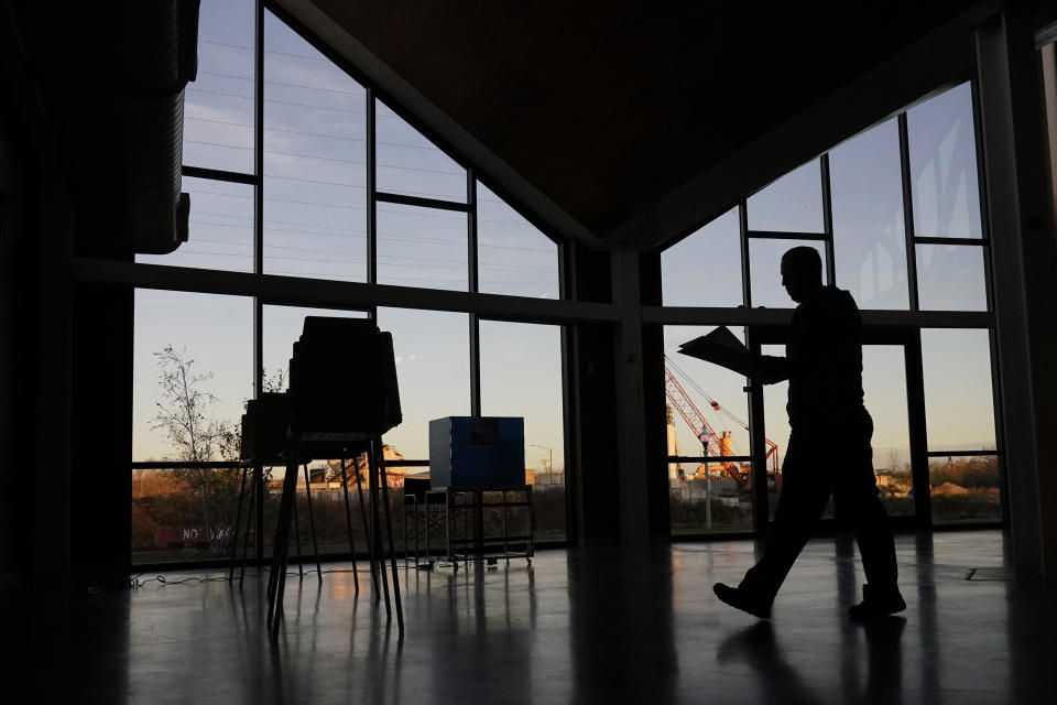 A voter walks to fill out his ballot at the Elenor Boathouse polling place on the Southside of Chicago, Tuesday, Nov. 8, 2022. (AP Photo/Charles Rex Arbogast)