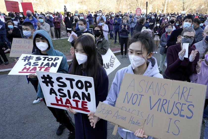 Protesters Dana Liu, center front, and Kexin Huang, right