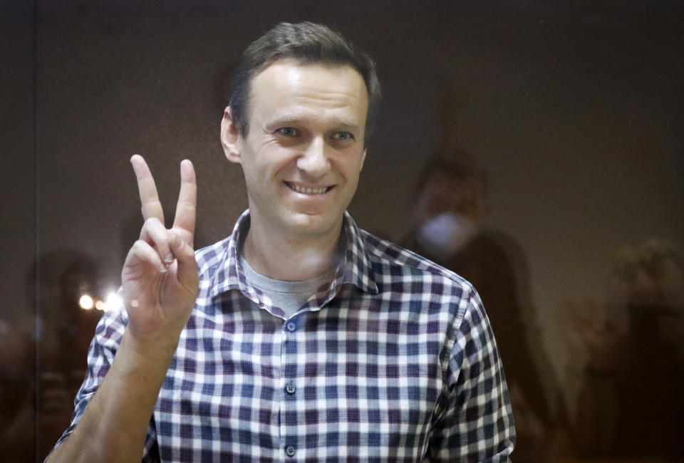 Navalny gives the peace sign during a court appearance in Moscow, Feb. 20, 2021. (Alexander Zemlianichenko/AP)