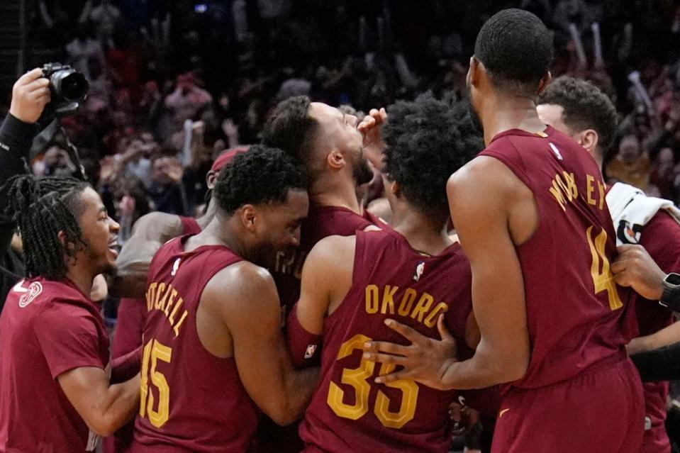 Cavaliers guard Max Strus, center, celebrates with teammates after hitting the game-winning basket against the Dallas Mavericks, Tuesday, Feb. 27, 2024, in Cleveland.