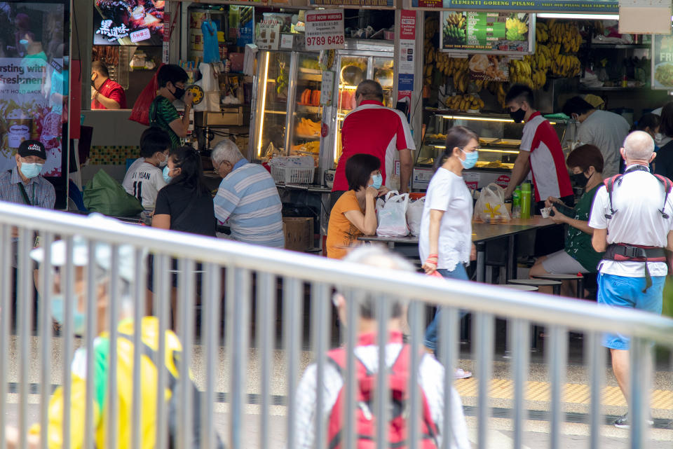 People seen eating at a hawker centre in Clementi on 19 June 2020, the first day of Phase 2 of Singapore’s re-opening. (PHOTO: Dhany Osman / Yahoo News Singapore)