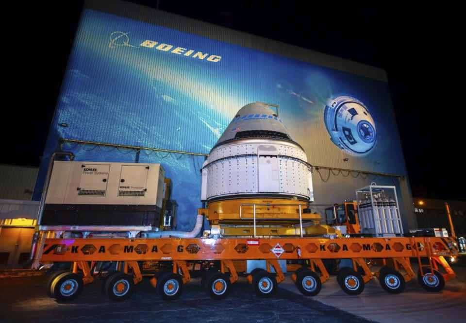 In this Nov. 21, 2019 photo the Boeing CST-100 Starliner spacecraft rolls out from the company’s Commercial Crew and Cargo Processing Facility at NASA’s Kennedy Space Center in Florida. Boeing has delayed its first test flight of its Starliner crew capsule to the International Space Station. The launch is now targeted for Dec. 19. (Boeing via AP)