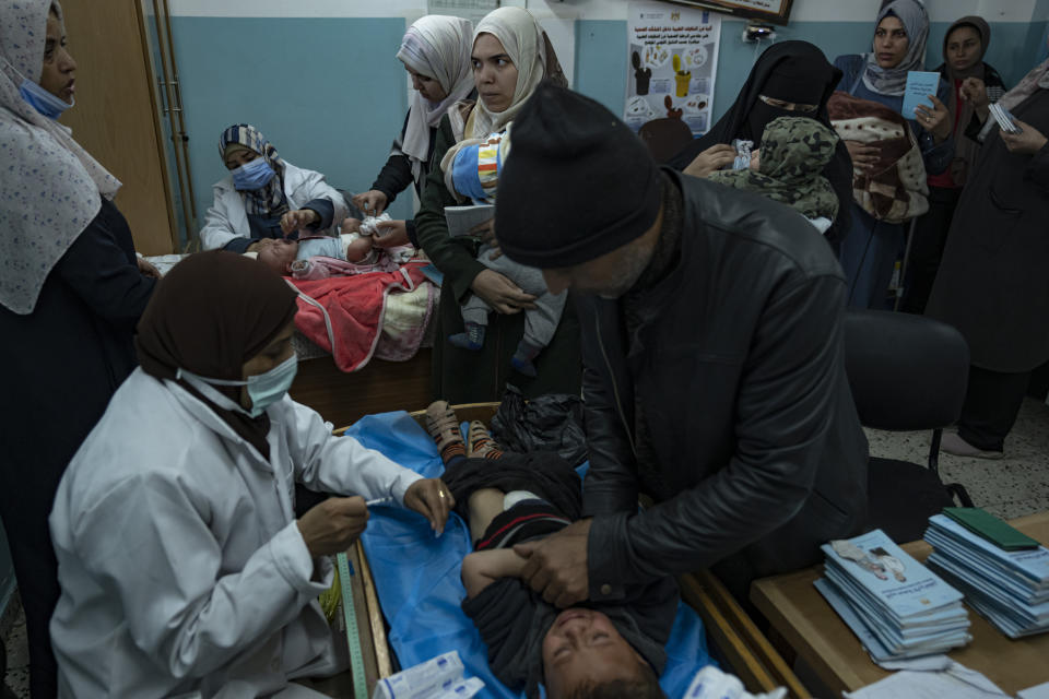 Palestinian children receive pentavalent vaccines in Rafah, Gaza Strip, Tuesday, Jan. 2, 2024. The vaccines, which protect against five diseases, recently entered Gaza in an international aid shipment and due to the ongoing war, most children are several months late for their immunizations. (AP Photo/Fatima Shbair)