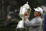 Collin Morikawa holds the Wanamaker Trophy after winning the PGA Championship golf tournament at TPC Harding Park Sunday, Aug. 9, 2020, in San Francisco. (AP Photo/Charlie Riedel)