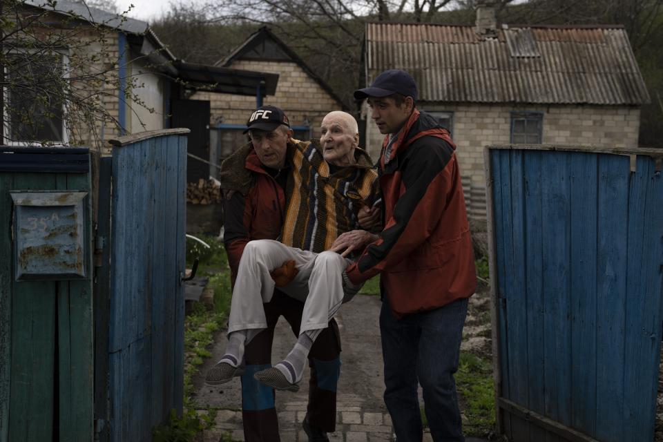Elderly people are evacuated from a hospice in Chasiv Yar city, Donetsk district, Ukraine, April 18, 2022. The image was part of a series of images by Associated Press photographers that was a finalist for the 2023 Pulitzer Prize for Feature Photography. (AP Photo/Petros Giannakouris)
