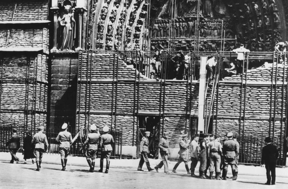 Clearing of sandbag protection from the facade of Notre Dame, German-occupied Paris, 1940.