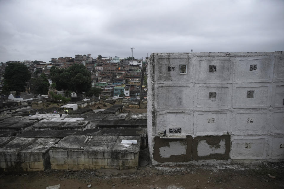 The niches that contain the remains of 4-year-old Emily Victoria Silva dos Santos and her 7-year-old cousin Rebeca Beatriz Rodrigues dos Santos, 7, are sealed with cement at the cemetery in Duque de Caxias, Rio de Janeiro state, Brazil, Saturday, Dec. 5, 2020. Grieving families held funerals for Emily and Rebeca, killed by bullets while playing outside their homes. Weeping and cries of “justice” were heard Saturday at their funerals, reflecting the families’ assertion that the children were killed by police bullets. (AP Photo/Silvia Izquierdo)