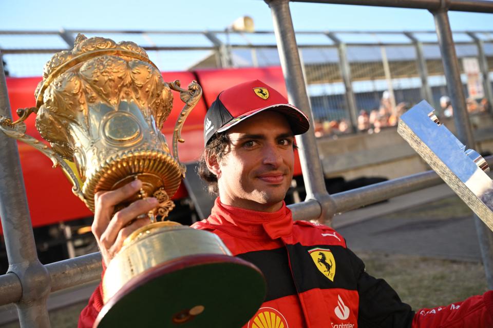 Ferrari's Spanish driver Carlos Sainz Jr poses with the winner's trophies after the Formula One British Grand Prix at the Silverstone motor racing circuit in Silverstone, central England on July 3, 2022. (Photo by JUSTIN TALLIS / AFP) (Photo by JUSTIN TALLIS/AFP via Getty Images)