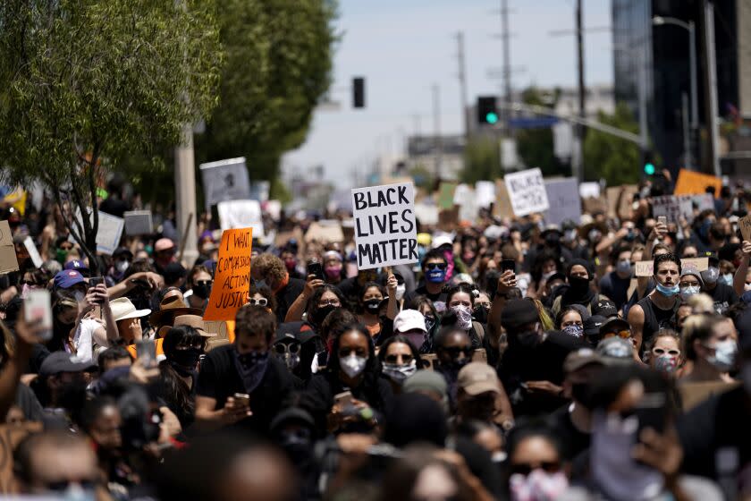 LOS ANGELES, CA - MAY 30: People at a gathering setup by groups Black Lives Matter Los Angeles and Build Power at Pan Pacific Park on Saturday, May 30, 2020 in Los Angeles, CA. Protests erupted across the country, with people outraged over the death of George Floyd, a black man killed after a white Minneapolis police officer pinned him to the ground with his knee. (Kent Nishimura / Los Angeles Times)