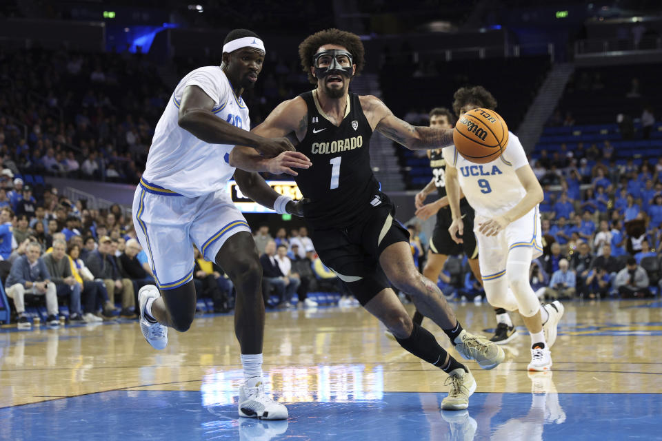 Colorado guard J'Vonne Hadley (1) dribbles past UCLA forward Adem Bona, left, during the first half of an NCAA college basketball game Thursday, Feb. 15, 2024, in Los Angeles. (AP Photo/Raul Romero Jr.)