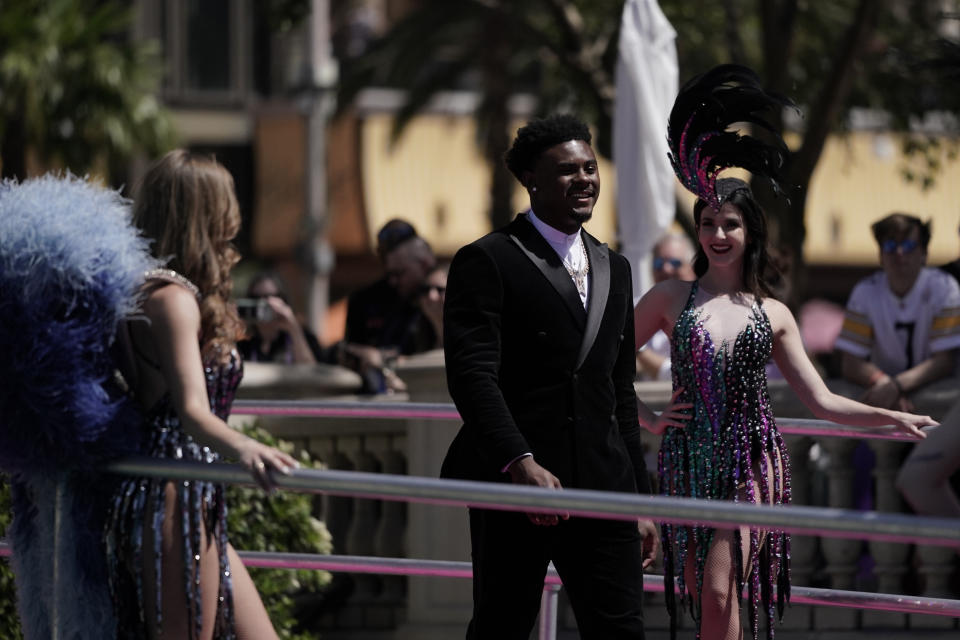 Liberty quarterback Malik Willis walks to the red carpet before the first round of the NFL football draft Thursday, April 28, 2022, in Las Vegas. (AP Photo/Jae C. Hong)