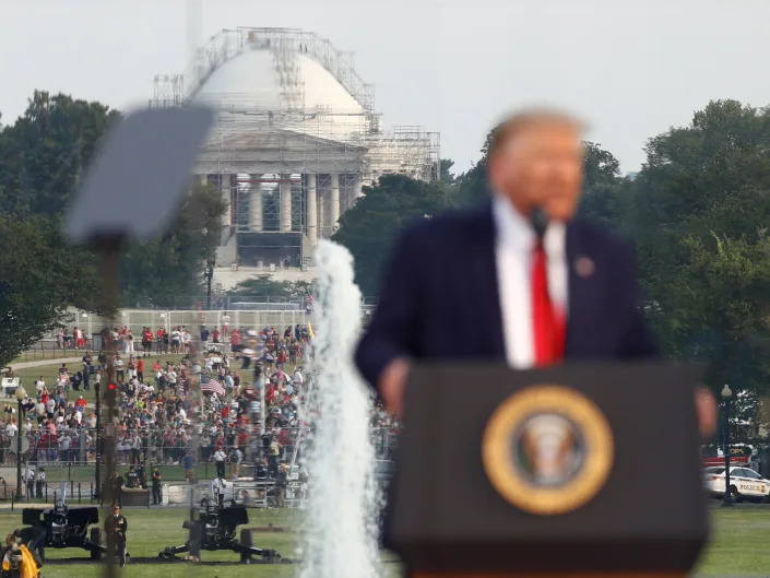 People gather on the National Mall as President Donald Trump speaks during a 