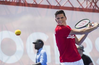 Milos Raonic returns a shot during an exhibition match on a tennis court atop a barge docked on Lake Ontario in Toronto on Wednesday, July 22, 2015. THE CANADIAN PRESS/Aaron Vincent Elkaim