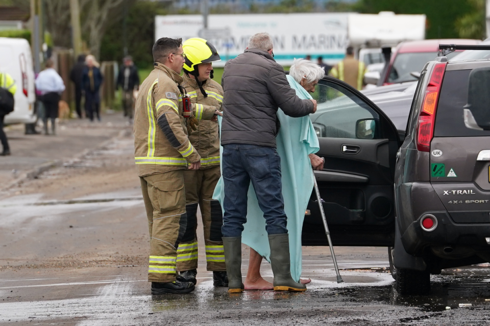 Firefighters evacuate an elderly resident near Rope Walk in Littlehampton (Gareth Fuller/PA Wire)