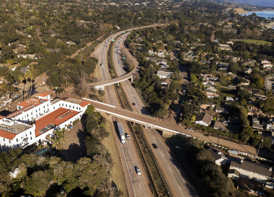 FILE - This Jan. 22, 2018 file photo from a news agency drone shows U.S. Highway 101 open to vehicle traffic in Montecito, Calif., after heavy rain brought flash flooding and mudslides that covered the highway two weeks earlier. In Utah, drones are hovering near avalanches to measure roaring snow. In North Carolina, they're combing the skies for the nests of endangered birds. In Kansas, meanwhile, they could soon be identifying sick cows through heat signatures. A survey released Monday, May 20, 2019 shows transportation agencies are using drones in nearly every U.S. state. (AP Photo/Daniel Dreifuss, File)