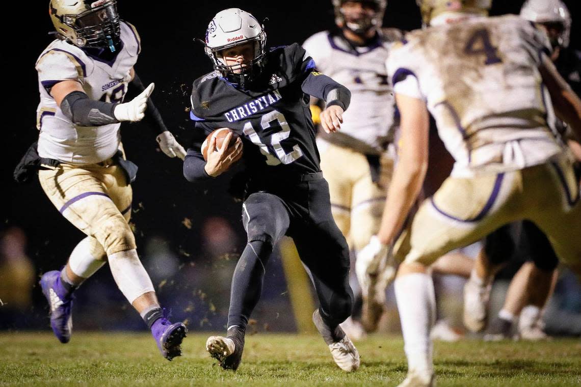 Lexington Christian’s Drew Nieves (12) carries the ball past Somerset defenders for a touchdown during the Class 2A district finals at LCA on Nov. 27, 2020.