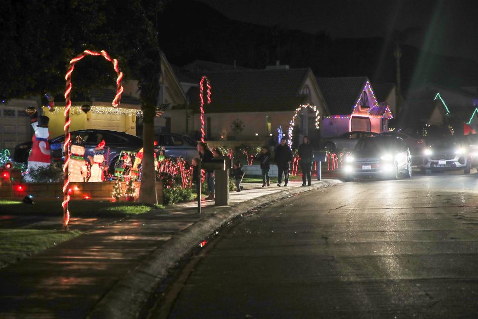 People experience Candy Cane Lane on foot and in cars on Minerva Road in Cathedral City, December 15, 2021.