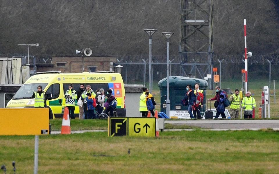 Some of the 83 Britons who were trapped in Wuhan disembark at RAF Brize Norton - GETTY IMAGES