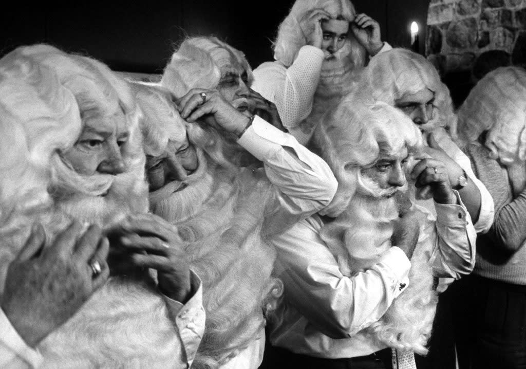 Students of the Santa school take turns to help each other perfect the look. (Alfred Eisenstaedt/The LIFE Picture Collection via Shutterstock)) 