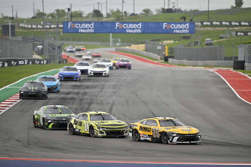 Christopher Bell (20), William Byron (24) and Tyler Reddick (45) steer through Turn 12 during a NASCAR Cup Series auto race on Sunday, March 24, 2024, at Circuit of the Americas in Austin, Texas. (AP Photo/Darren Abate)