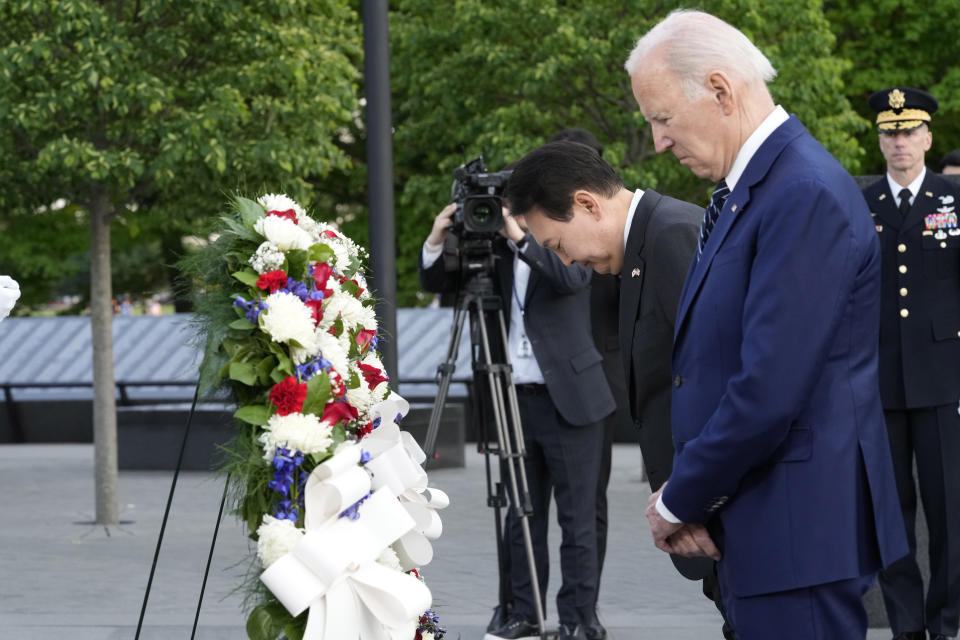President Joe Biden and South Korea's President Yoon Suk Yeol pause as they lay a wreath during a visit the Korean War Veterans Memorial in Washington, Tuesday, April 25, 2023. (AP Photo/Susan Walsh)