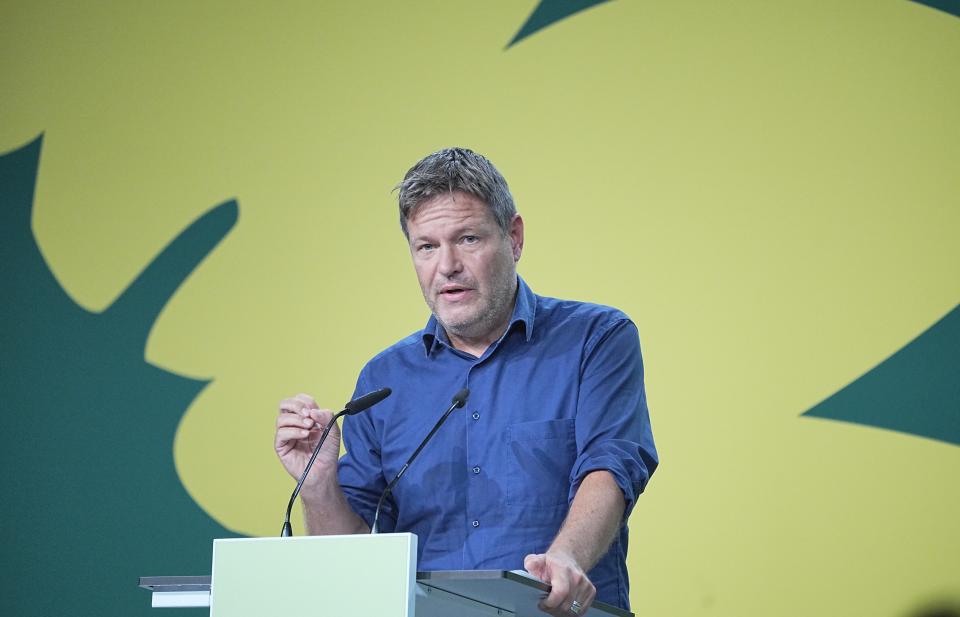 Robert Habeck, federal leader of the Greens, gestures during his speech at a congress in Berlin, Germany, Sunday, Oct. 17, 2021. Germany's Green party is deciding whether to open formal coalition talks on a new government that would speed up the country's exit from coal-fueled power and the expansion of renewable energy. (Michael Kappeler/dpa via AP)