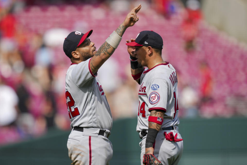 Washington Nationals' Dominic Smith, left, celebrates with Ildemaro Vargas, right, after the final out of a baseball game against the Cincinnati Reds in Cincinnati, Sunday, Aug. 6, 2022. (AP Photo/Aaron Doster)