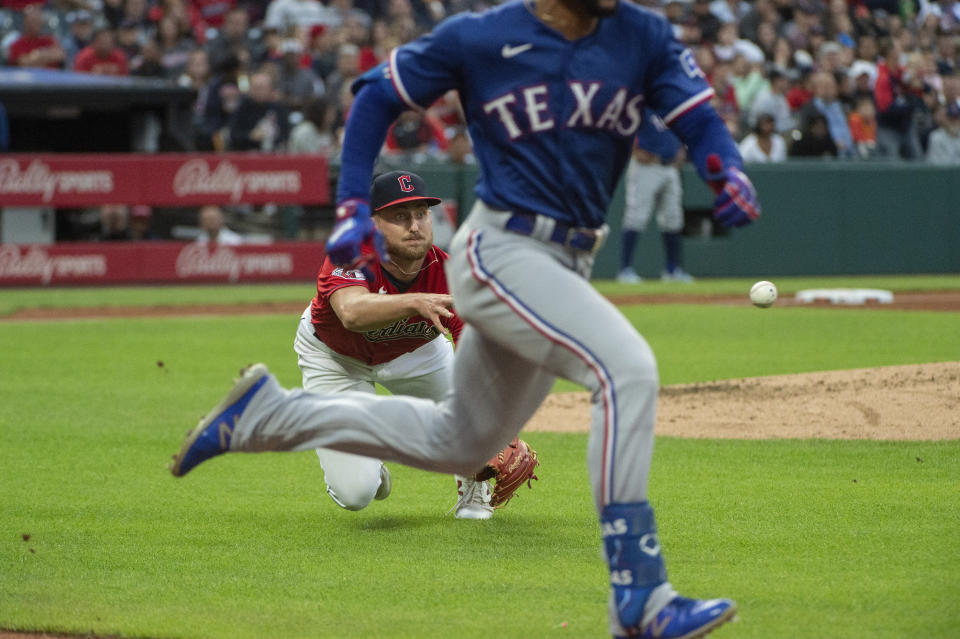 Cleveland Guardians starting pitcher Tanner Bibee, back left, throws out Texas Rangers' Leody Taveras, front right, during the fifth inning of a baseball game in Cleveland, Saturday, Sept. 16, 2023. (AP Photo/Phil Long)