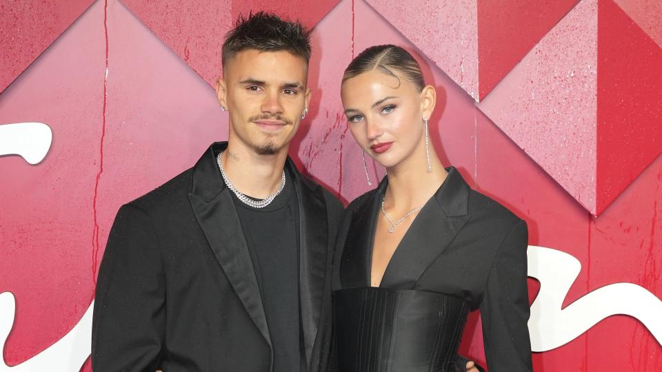 Romeo Beckham and Mia Regan on red carpet in black outfits