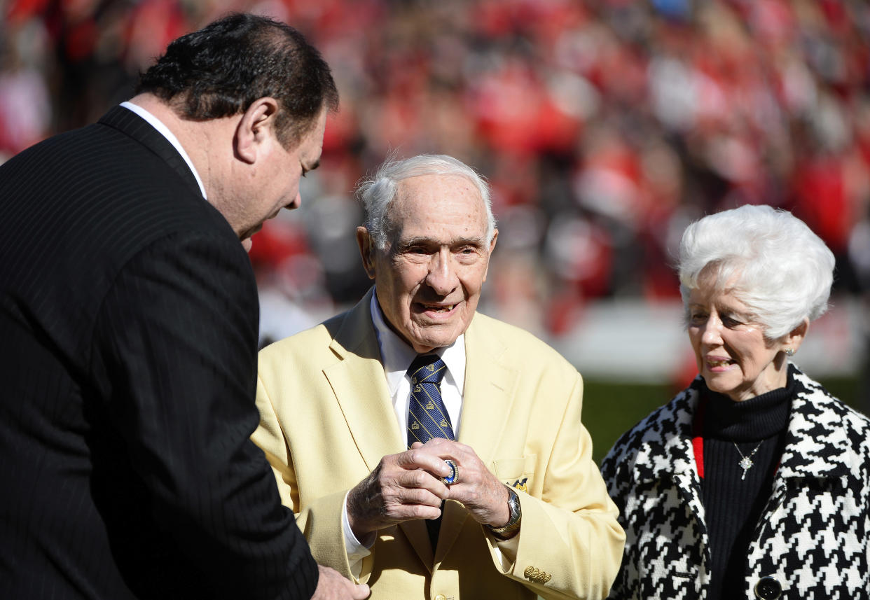 FILE - Former Georgia player Charley Trippi, a two-time All-Amercian, receives a College Football Hall of Fame ring during the first half of an NCAA college football game between Georgia and Georgia Tech on Nov. 29, 2014, in Athens, Ga. Trippi, a runner-up for the Heisman Trophy at Georgia who went on to lead the Cardinals to their most recent NFL championship in 1947, died Wednesday, Oct. 19, 2022. He was 100. (AP Photo/David Tulis, File)